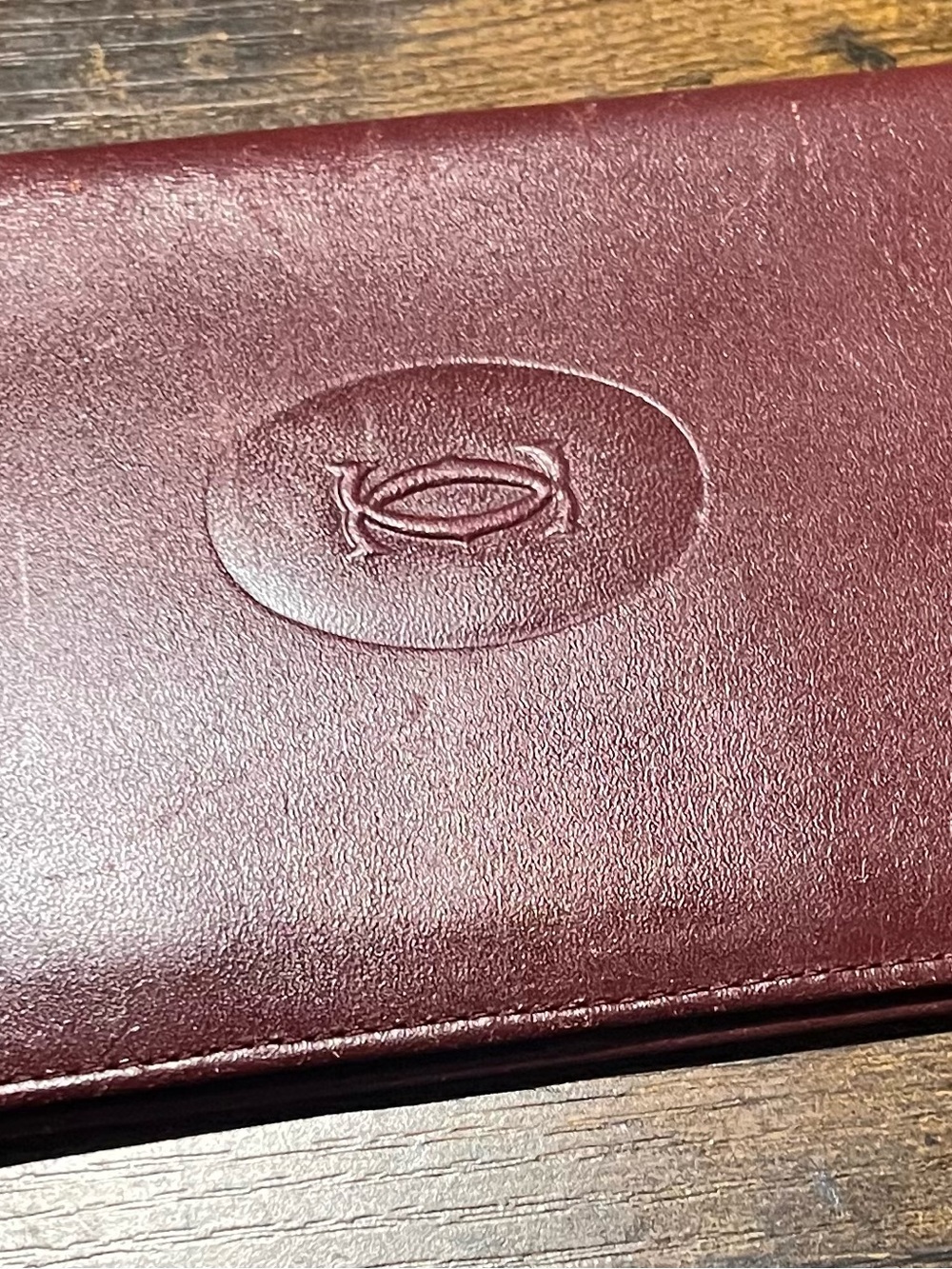Cartier Burgundy Embossed Leather Long Wallet in Good to Fair Condition.